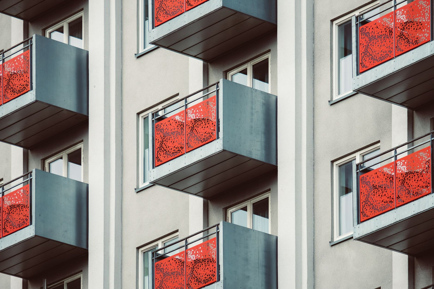 Stylish modern apartment building with distinctive red balconies in Oslo.