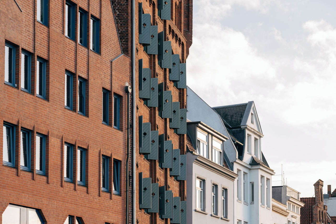View of Lübeck's red brick Gothic facades and distinct shutters, showcasing urban architecture.