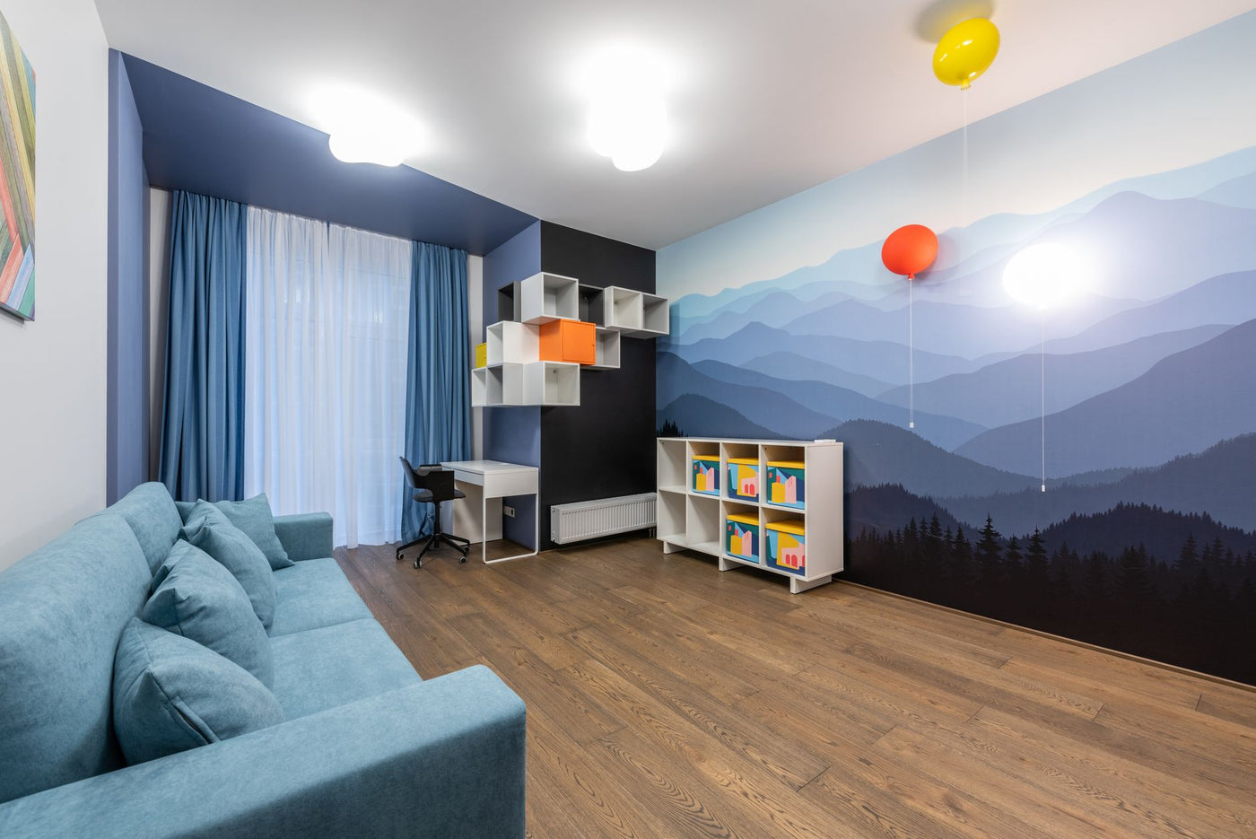 Modern interior of large room with contemporary cabinets and soft blue sofa with pillows