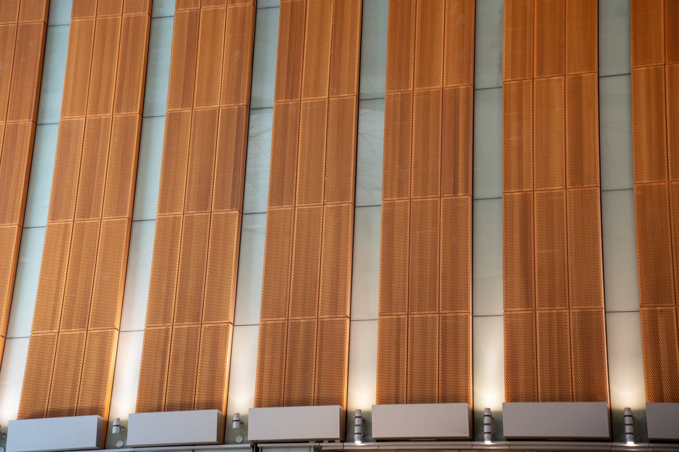 Contemporary facade in Doha, featuring a modern architectural design with vertical copper panels.