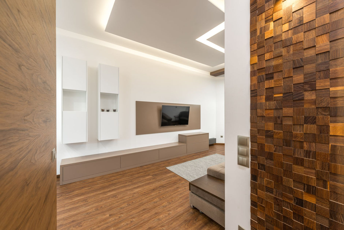 Sleek and stylish living room design with TV and wooden textures.