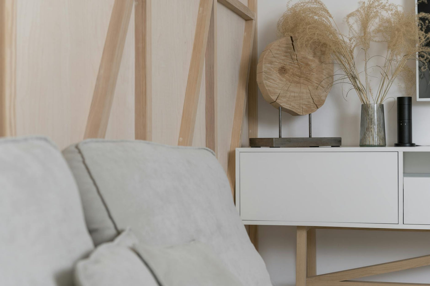 Elegant minimalist interior featuring pampas grass and modern decor elements on a sleek sideboard.