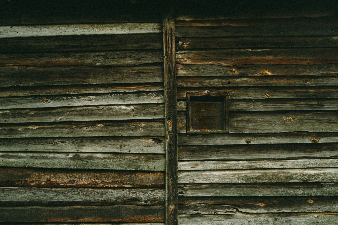 Close-up of a rustic wooden cabin wall in Poland showcasing weathered texture.