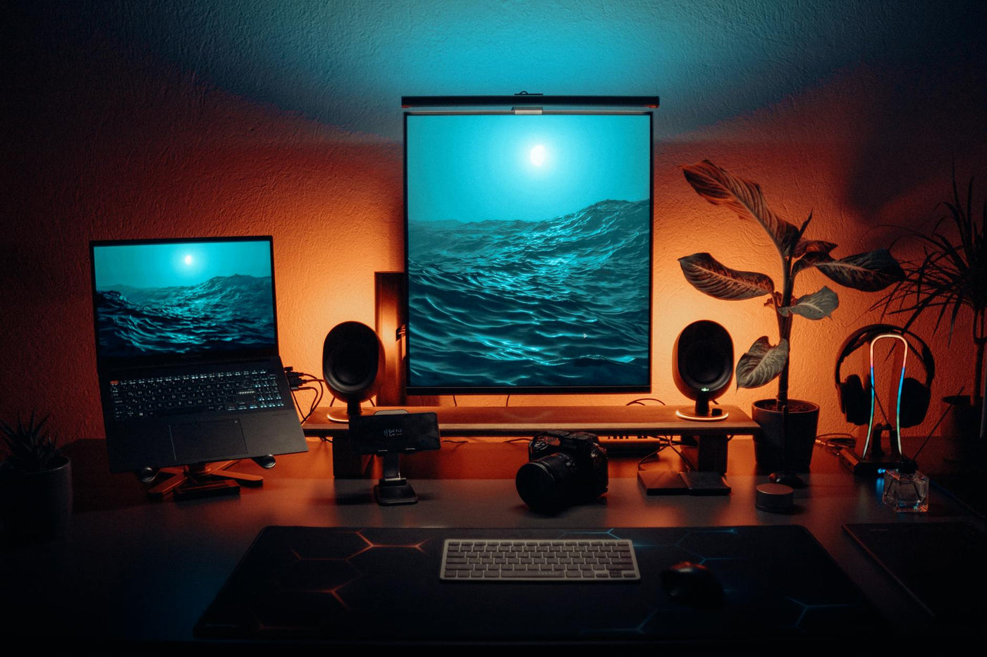 Stylish office setup featuring dual monitors, tech gadgets, and ambient lighting.
